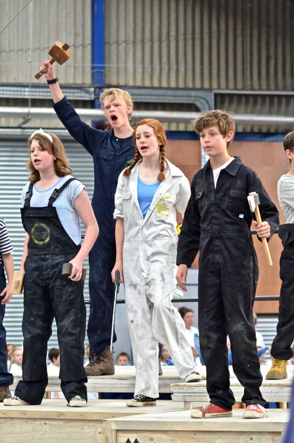 Four children performing on stage