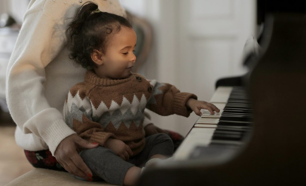 Young pre school aged child plays piano