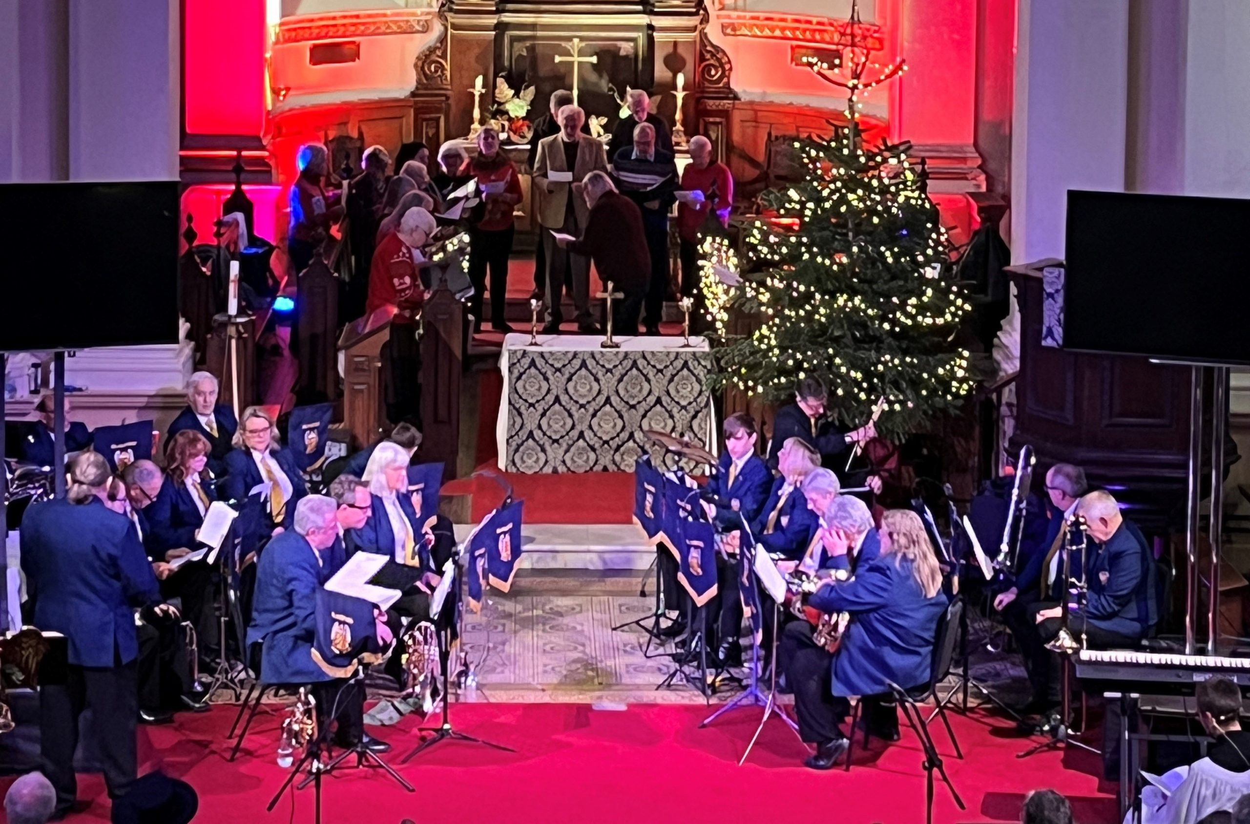Orchestra plays in church with Christmas Tree